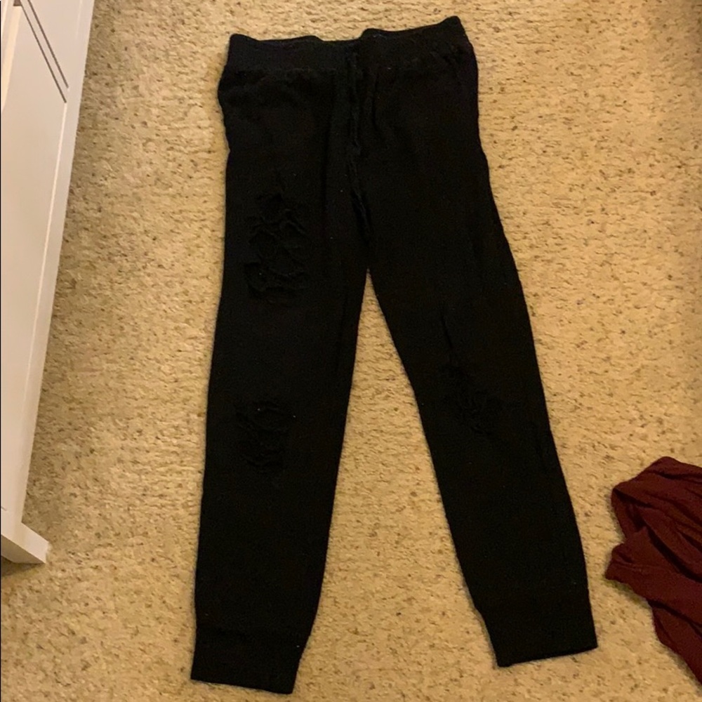 Ripped black sweatpants.